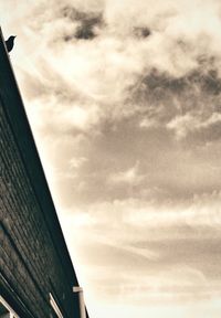 Low angle view of building against cloudy sky