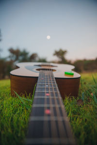 Close-up of guitar on field