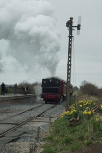 Train on railroad tracks against sky