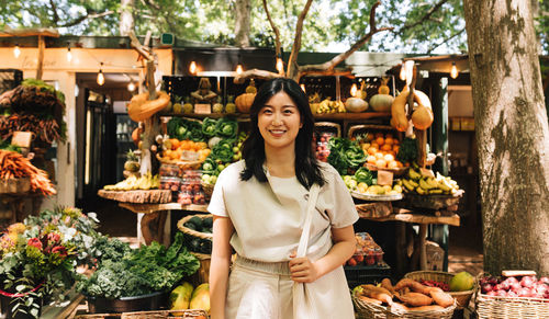 Portrait of smiling woman standing in market