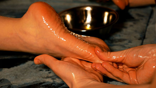 Cropped hands of male masseur massaging female customer at beauty spa