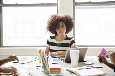 Portrait of confident businesswoman sitting in board room