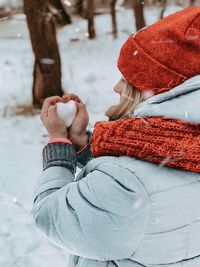 Midsection of woman holding umbrella during winter