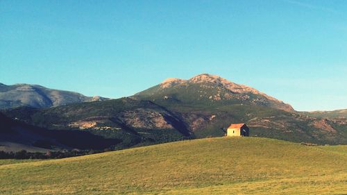 Scenic view of mountains against clear blue sky