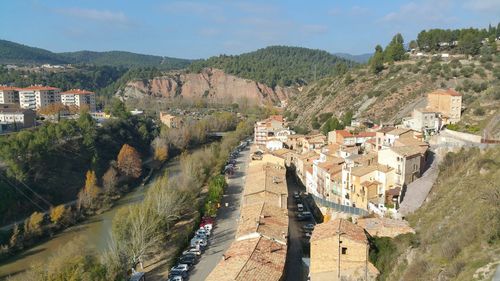 High angle view of townscape and mountains against sky