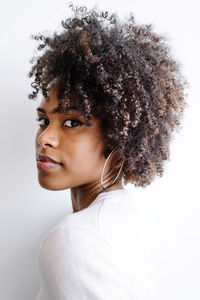 Portrait of a beautiful black woman with afro on the white background