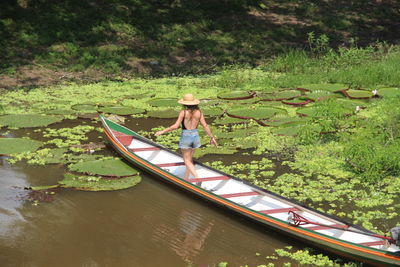 Rear view of woman kayaking in lake