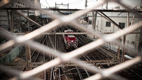 Railroad tracks seen through chainlink fence