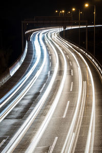 High angle view of light trails on highway at night