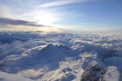 Aerial view of snowcapped mountains against sky