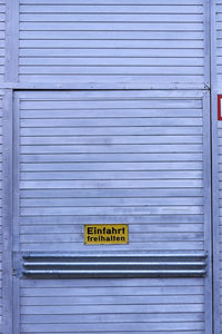 Text on closed gray door of garage