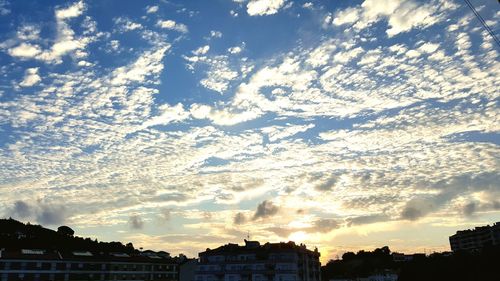 Low angle view of silhouette trees against sky