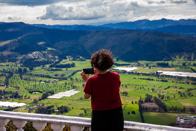 Young woman at a viewpoint over the  sopo valley at the department of cundinamarca in colombia