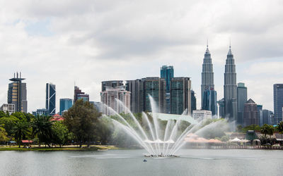 View of skyscrapers against cloudy sky