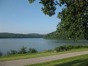 Scenic view of lake and mountains against clear sky
