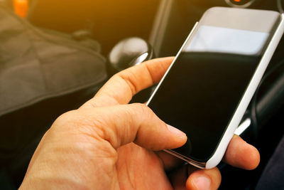 Cropped hand of woman using mobile phone