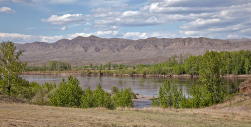 Scenic view of lake and mountains against sky