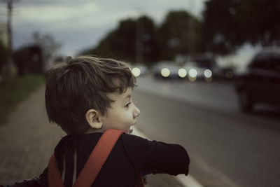 Close-up of cheerful boy on footpath