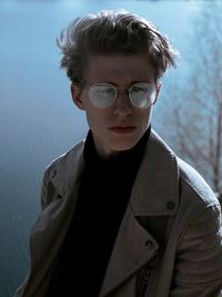 Portrait of young man wearing sunglasses standing outdoors