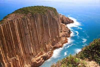 High angle view of cliff by sea