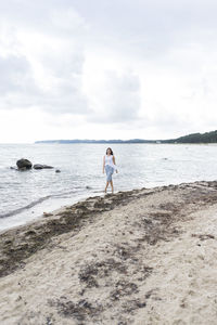 Full length of man on beach against sky