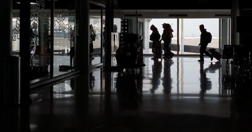 Silhouette people walking in airport