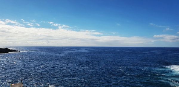 Scenic view of sea against blue sky