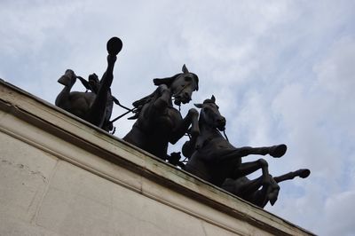 Low angle view of statue against sky