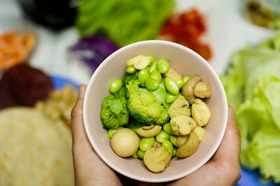 Close-up of hand holding salad