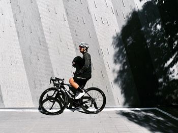 Man riding bicycle on wall