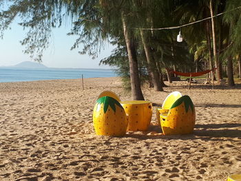 Yellow umbrella on beach against sky