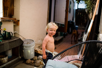 Portrait of smiling boy sitting outdoors