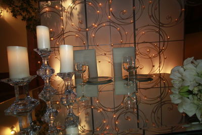 Close-up of illuminated candles on table