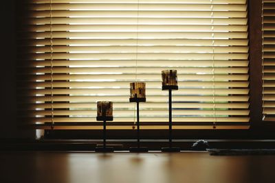 Lamps against blinds window at home