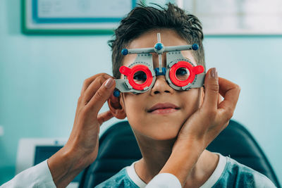 Smiling ophthalmologist doing eye test of boy