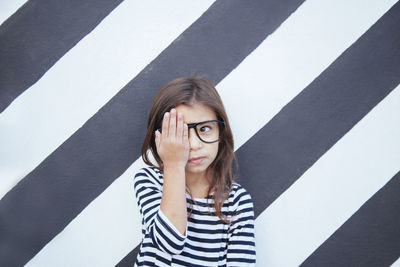 Portrait of woman against wall