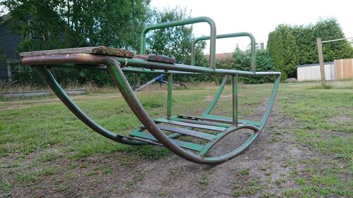 Empty playground against trees in park