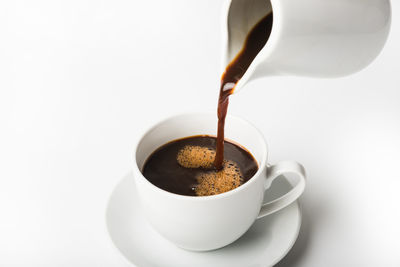 Close-up of coffee cup over white background