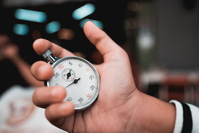 Close-up of hand holding stopwatch