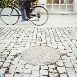 Low section of people walking on sidewalk