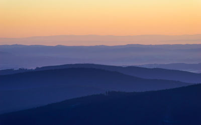 Scenic view of silhouette mountains against sky during sunset