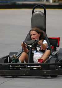 High angle view of girl go-cart racing on track