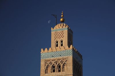 Low angle view of mosque with moon