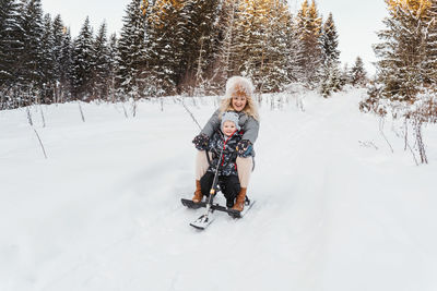 Full length of woman on snow covered trees during winter