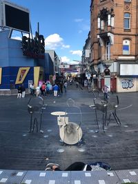 People on street against buildings in city