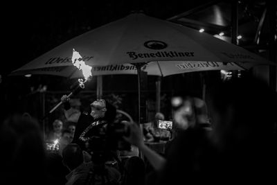 Group of people at music concert in city at night