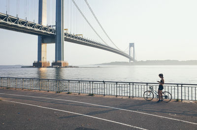 Bridge over river with city in background