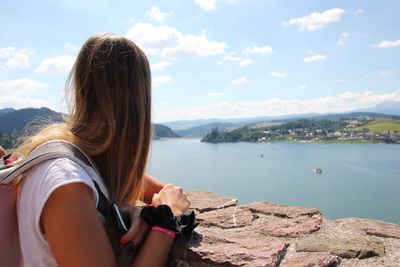 Rear view of woman on mountain against sky