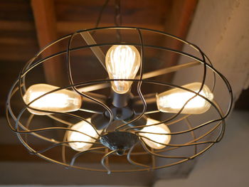 Close-up of illuminated light bulb on table