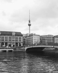 View of buildings in city against cloudy sky